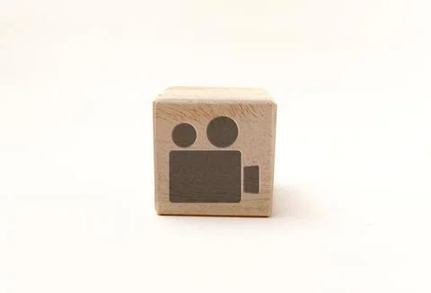 Single wooden block cube featuring a gray video movie camera icon on natura.. Stock Photos