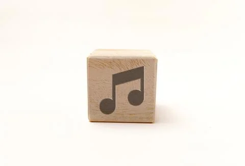 Single wooden block cube featuring a gray musical note icon on natural grai.. Stock Photos