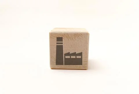 Single wooden block cube featuring a gray factory industrial icon on natura.. Stock Photos