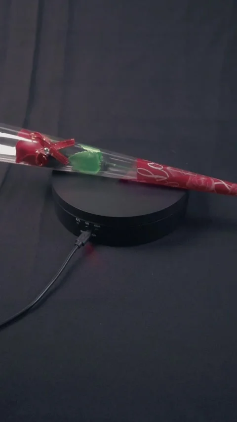 Single Wrapped Red Rose Gift Rotating On Black Turntable Display Stock Footage 322606724