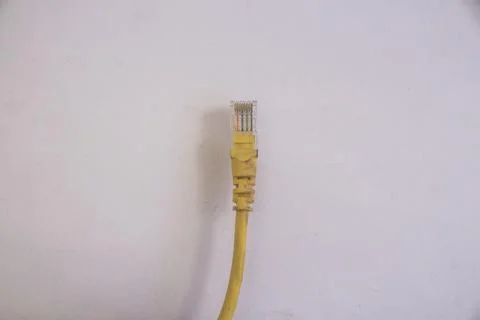 Single yellow network cable isolated in white background Stock Photos