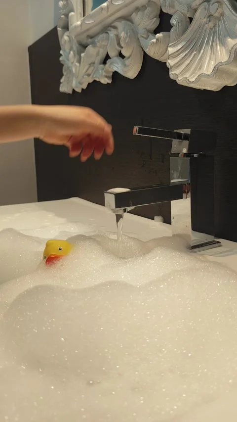 Single Yellow Rubber Duck in White Soap Foam Stock Footage 328192917