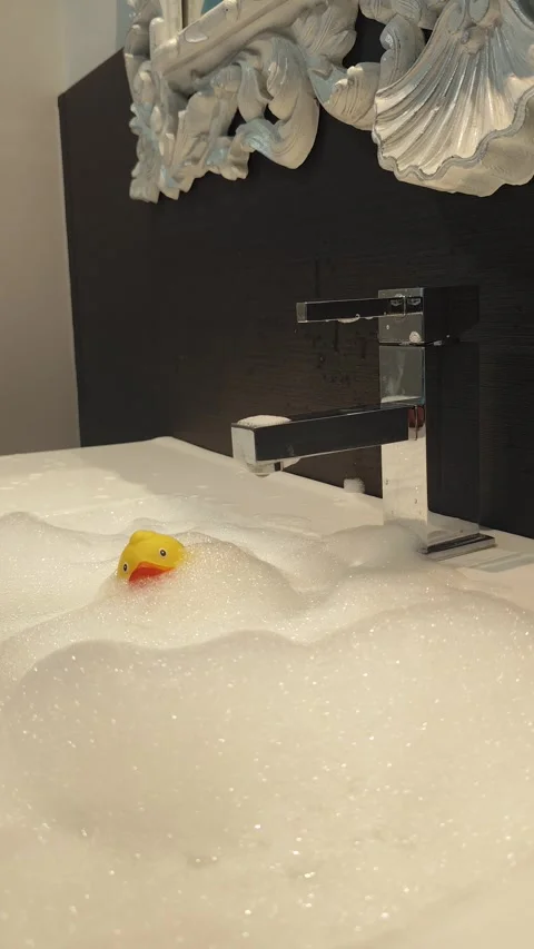 Single Yellow Rubber Duck in White Soap Foam Stock Footage 328192951