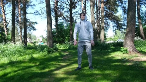 Single young man doing exercises in the forest park, street workout Stock Footage 136235954