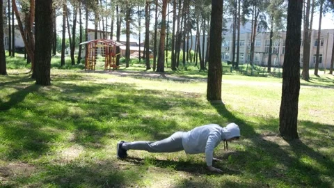 Single young man doing exercises in the forest park, street workout Stock Footage 136236297