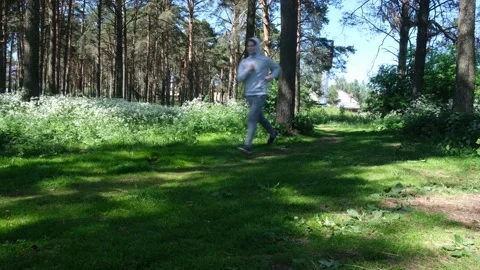 Single young man running in the forest park, street workout Stock Footage 136235708