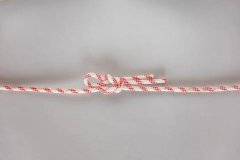 Singly slipped reef ship knot on grey background Stock Photos