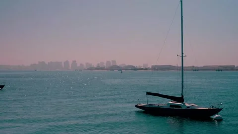 Singular Boat Floating in Bay with San Diego City Scape in the Background Video stock 346787314