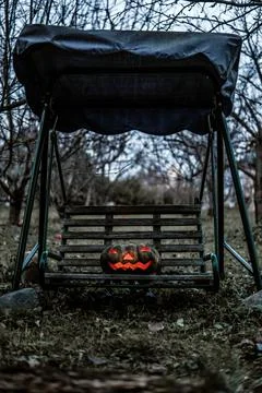 Sinister pumpkin on a swing Stockfoto's