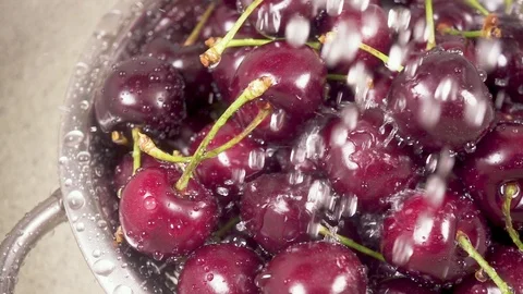 In the sink cherry in a colander under the water slow motion Stock-Footage 90488382