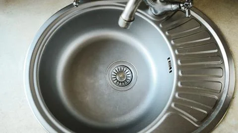 Sink clean and empty with drain in center, Stock Photos