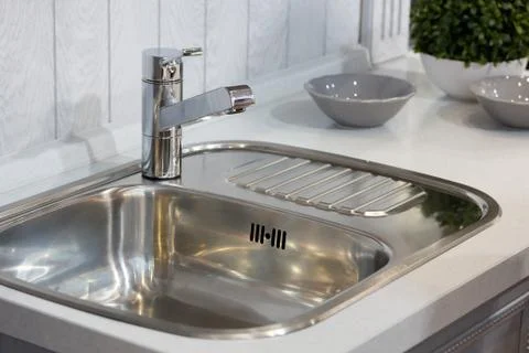 Sink with a tap in a kitchen Stock Photos
