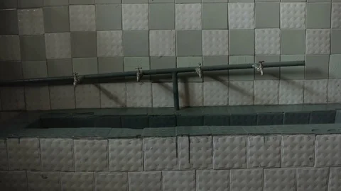 Sink with taps in the old Soviet and Nazi prison cell Stock Footage