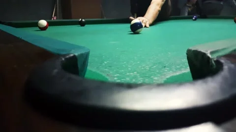 Sinking ball number 10 with a soft shot in billiard pocket in an eight ball game Stock Footage 58952263
