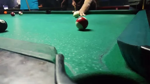 Sinking the ball number 11 with hard shot to billiard pocket in eight ball game Stock Footage 58952475