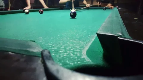 Sinking ball number 4 with spider rest head in billiard pocket in eight ball Stock Footage 58952451