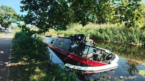 Sinking Canal Boat next to Walking Path in Dublin City Stock Footage 340423006