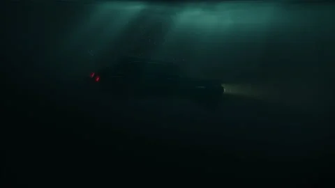 Sinking car with headlamps and bubbles in dark water under sun rays Stockbeeldmateriaal 136096798