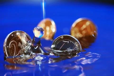 Sinking coins Stock Photos