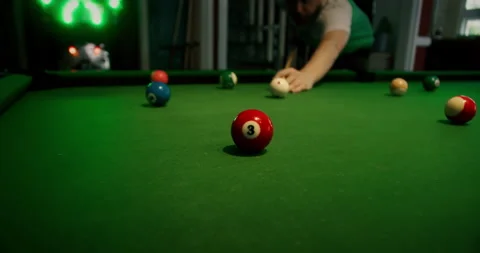 Sinking yellow ball number one into a pocket.Sports game of billiards on a green Stock Footage 218246153