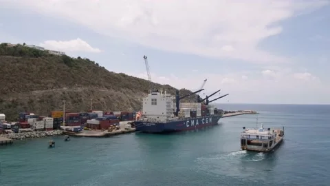 SINT MAARTEN - 12 OCTOBER 2022: barge in Sint Maarten cargo port waters for Stock Footage 233398341