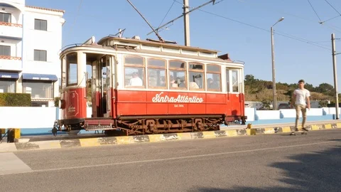 The Sintra tramway is a narrow gauge tourist tram line. Young man on skateboard Stock Footage 122321453