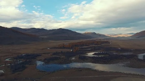 The sinuous course of the river flows along the mountainous terrain Stock Footage 82213031