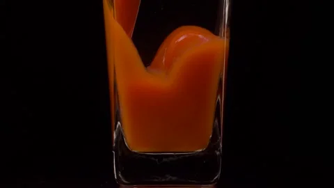 Sip It. Super slow motion shot of pouring tomato juice into a transparent glass Video stock 147412680