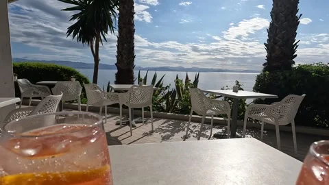 Sip refreshing cocktails while enjoying stunning views of Corfu during sunset Video stock 285596491