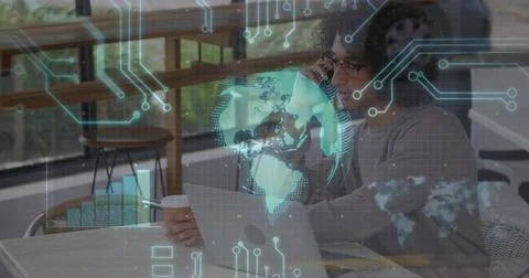 Sipping coffee man analyzing data on laptop at cafe table, with holographic Stock Photos