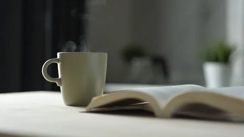 Sipping Coffee While Reading a Book in a Cozy Room Still Life Scene Home Stock Footage 295802081