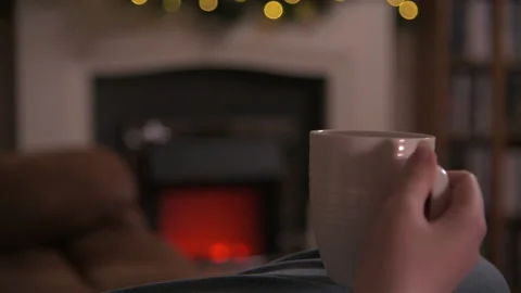 Sipping Drink By Cosy Fire Stock Footage 145133588
