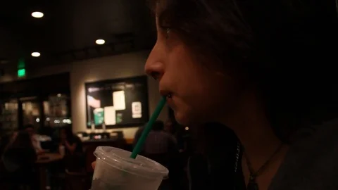 Sipping a drink in Starbucks Stock Footage 78894063