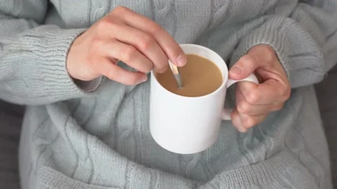 Sipping hot cup of coffee on the couch Stock Footage 143187312