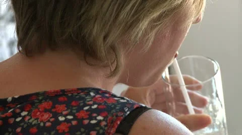 Sipping water through a straw Stock Footage 8981581