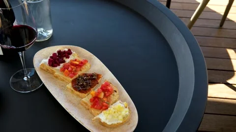 Sipping wine paired with small bites, Enjoying appetizers alongside Stock Footage 288905975