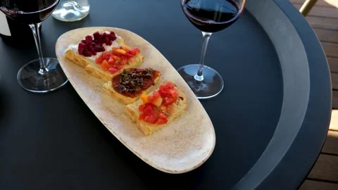 Sipping wine paired with small bites, Enjoying appetizers alongside Stock Footage 288908780