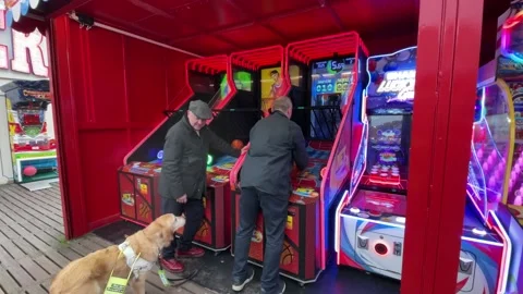 Sir Ed Davey plays arcade games and crazy golf on visit to Paignton Pier in Dev Video stock 301393933