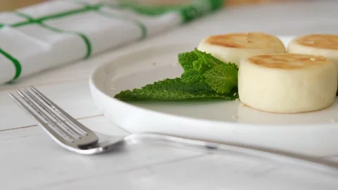 Sirniki, cheese pancake, cheesecake with berries decorated with mint on a plate. Stock Footage 154631753