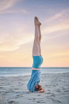 Sirsasana Headstand Inversion Pose on Beach at Sunset Stock Photos