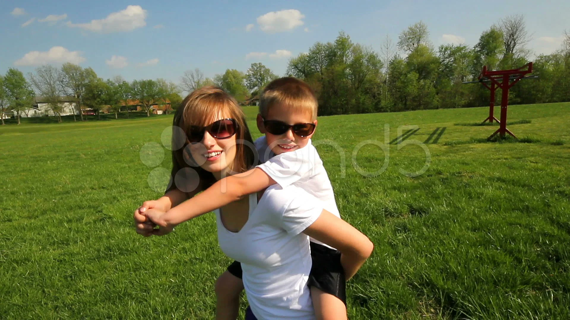 Young girl carrying sister giving piggyback ride Stock Photo