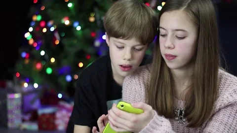 Sister holding Tablet while Brother operates it  Stock Footage 72404393