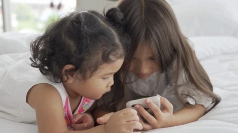 Sisters and sisters are using three smartphones. Stock Footage 116379633