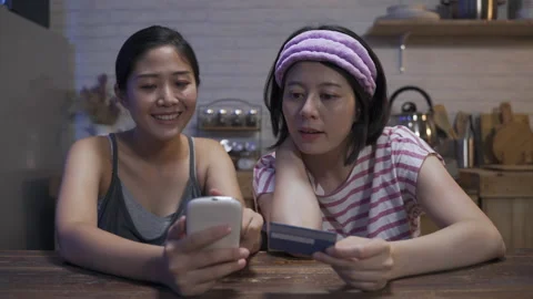 Sisters are making an online payment Stock Footage 182869444