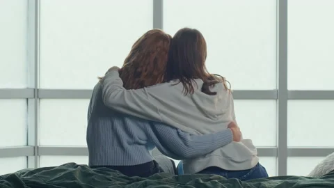 Sisters Back View Sitting on Bed Near Panoramic Window. Mental Health. Stock Footage 212218162