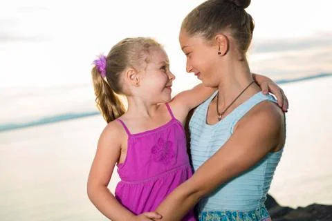 Sisters at the beach on sunset Stock-Fotos