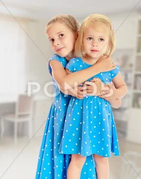 Sisters in blue dresses Stock Photos