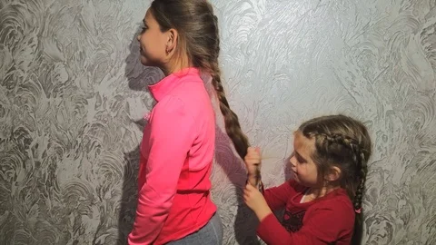 Sisters comb the braids1 Stock Footage 98300535