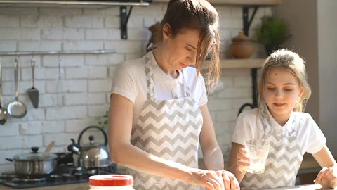 Sisters cooking at the kitchen. Stock Footage 106238112