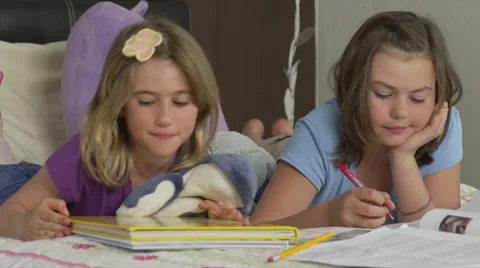 Sisters Doing Homework on Bed Stock Footage 35233470